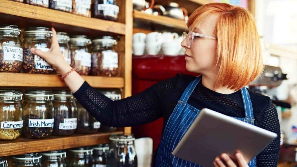 A woman checking her stocked shelves