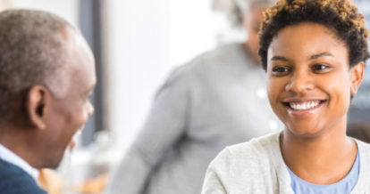 A woman smiling at a man.