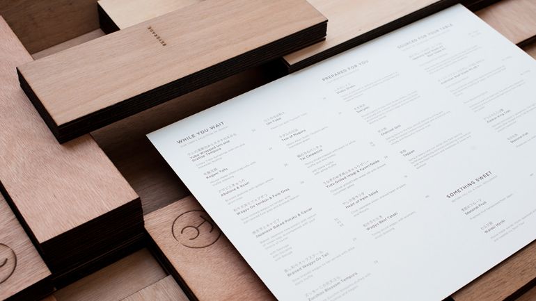 A minimal menu surrounded by wooden blocks