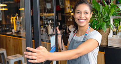 Restaurant employee opening the door to the restaurant