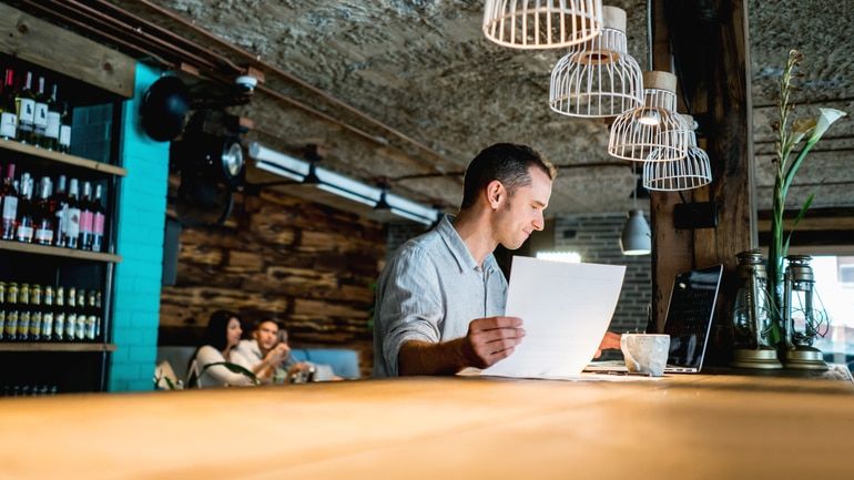 Man on a laptop in a restaurant