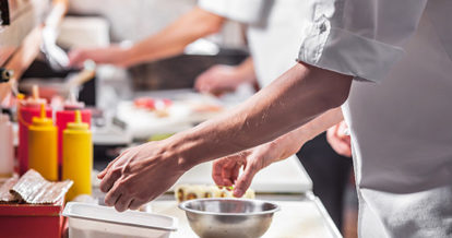 Chef prepping food behind the line