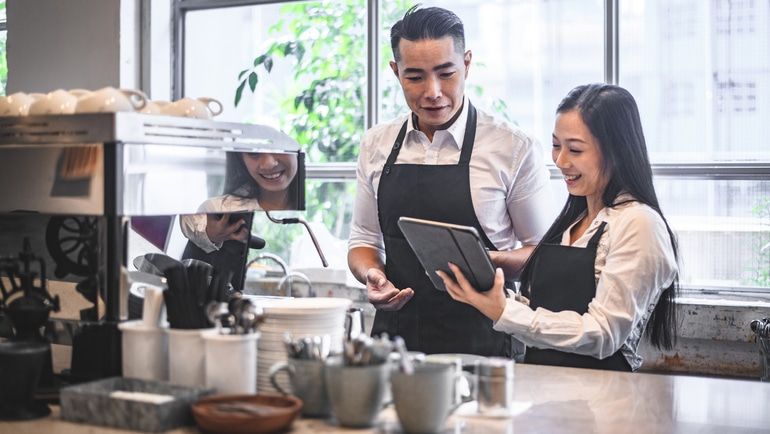 Cafe workers using an iPad