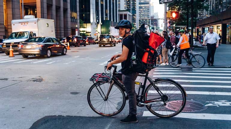 A cyclist waiting at a stop light