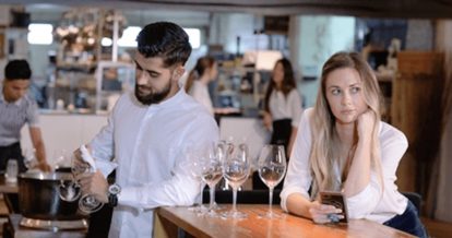 Serving staff polishing glasses and waiting for customers to serve