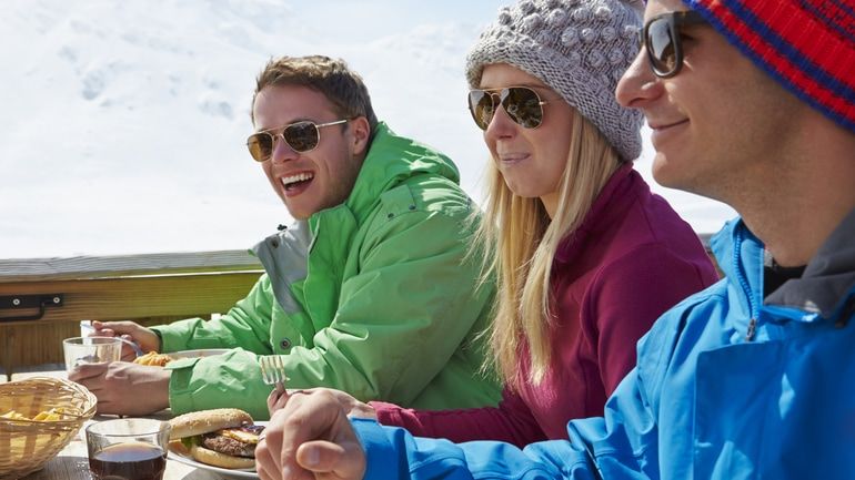 Group of friends enjoying a meal outside during winter