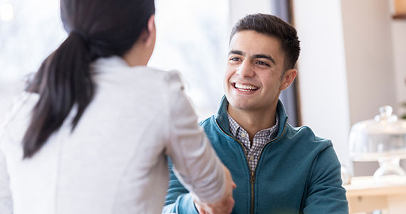 Man and woman shaking hands in a restaurant