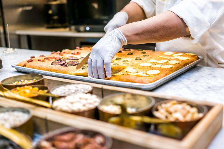 Chef wearing gloves prepping food