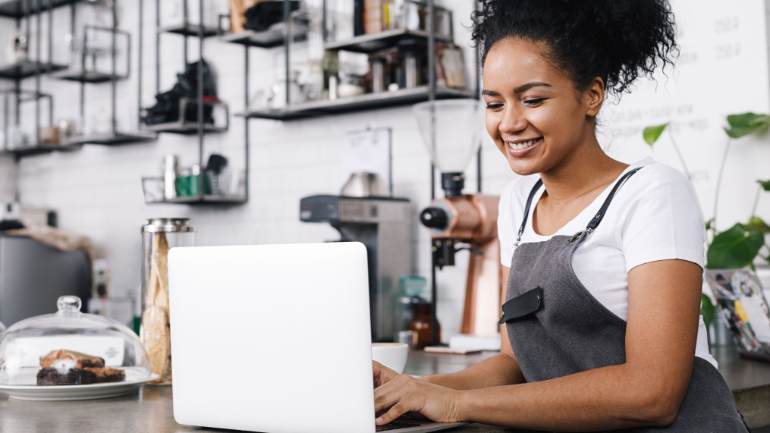 Cafe owner working on laptop