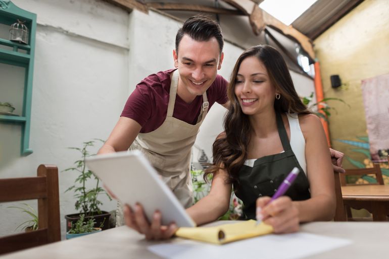 Couple working together on an iPad POS