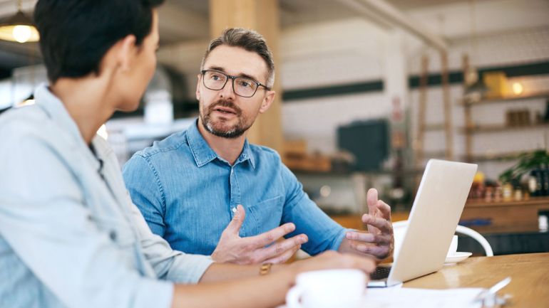 Restaurant owner having a conversation with worker