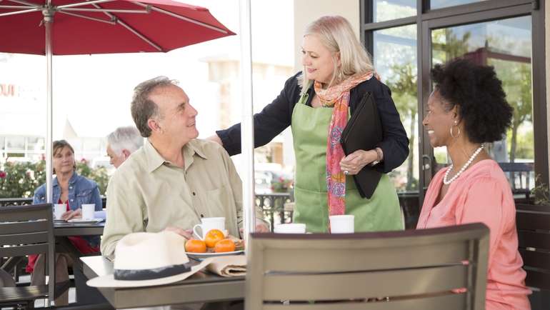 Restaurant manager checking in on diners