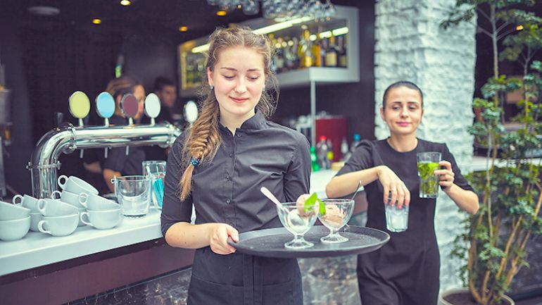 Server bringing desserts on a tray