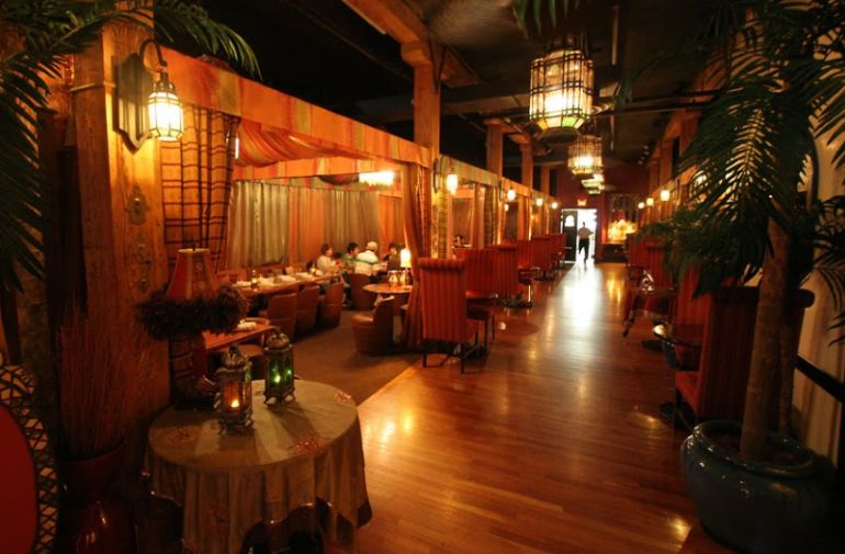 Soft lighting and palm trees create ambiance at the Sultan's Tent and Cafe, one of the most unique restaurants in Toronto.