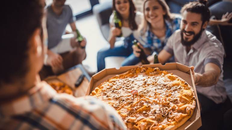 Friends enjoying take away pizza