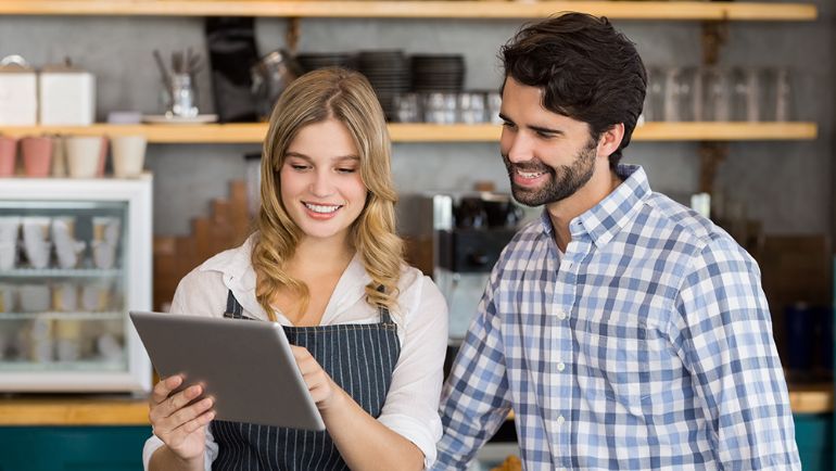 restaurant employees looking at a POS