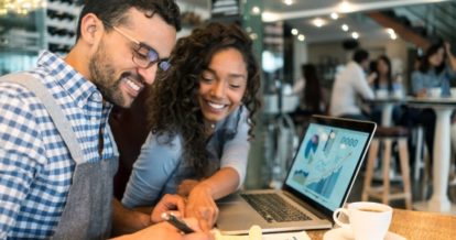 restaurant managers working together at a laptop