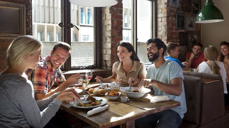 Friends enjoying food at a restaurant.