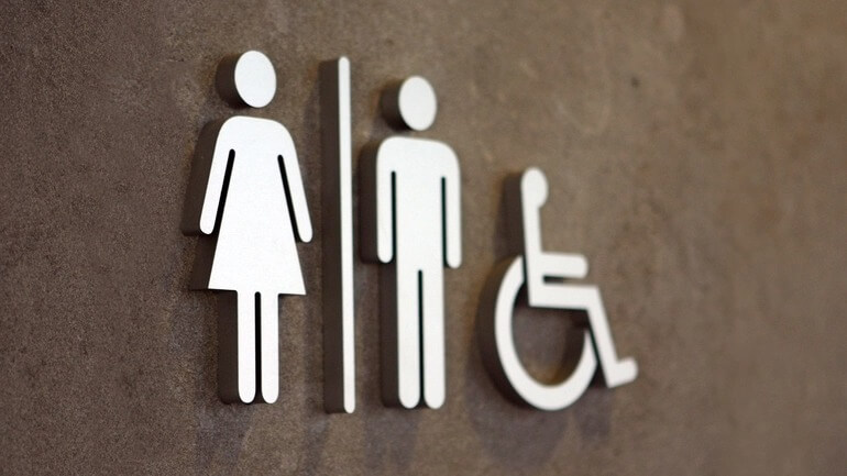 An accessible bathroom sign on a door.