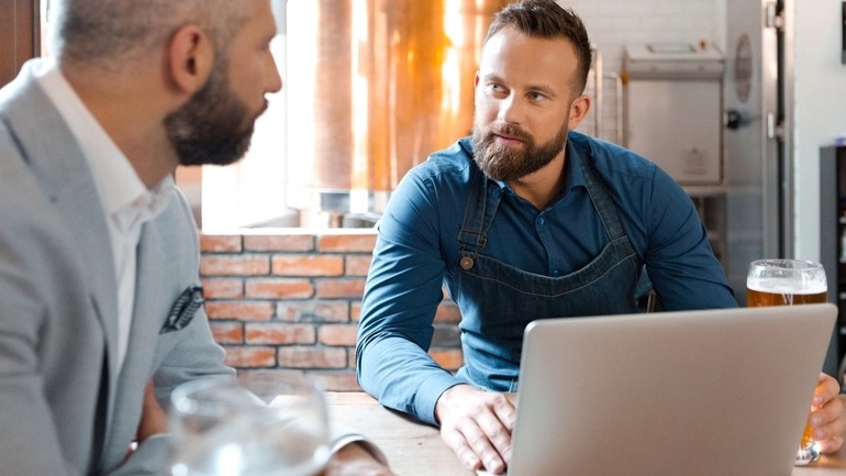 A brewery owner and investor discussing a brewery business plan.