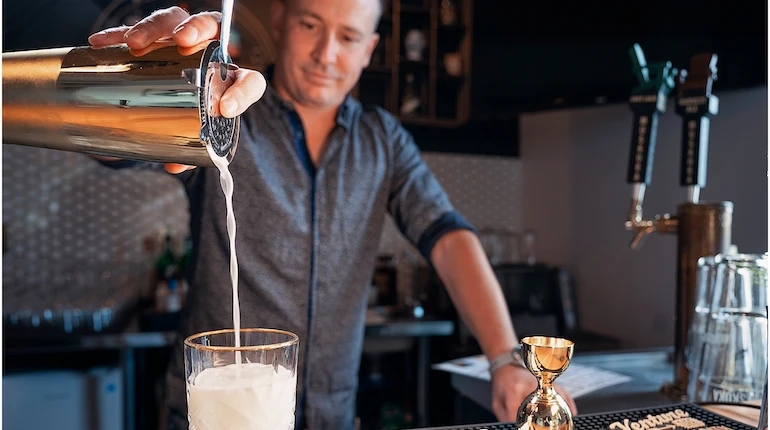 Bartender pouring a cocktail at B'Spoke Kitchen + Market.