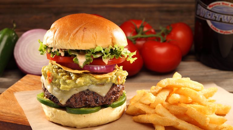 A photo of a cheeseburger and fries at Sweetwater Sports Bar & Grill.