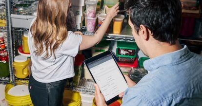 Restaurant staff using TouchBistro Inventory Management software on a tablet.