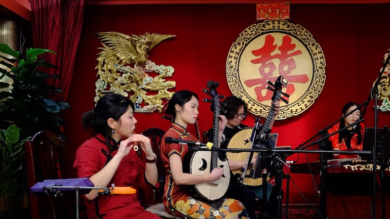 A group of performers playing instruments at Kiyooka Ohe Arts Centre & Sculpture Park in celebration of Chinese New Year.